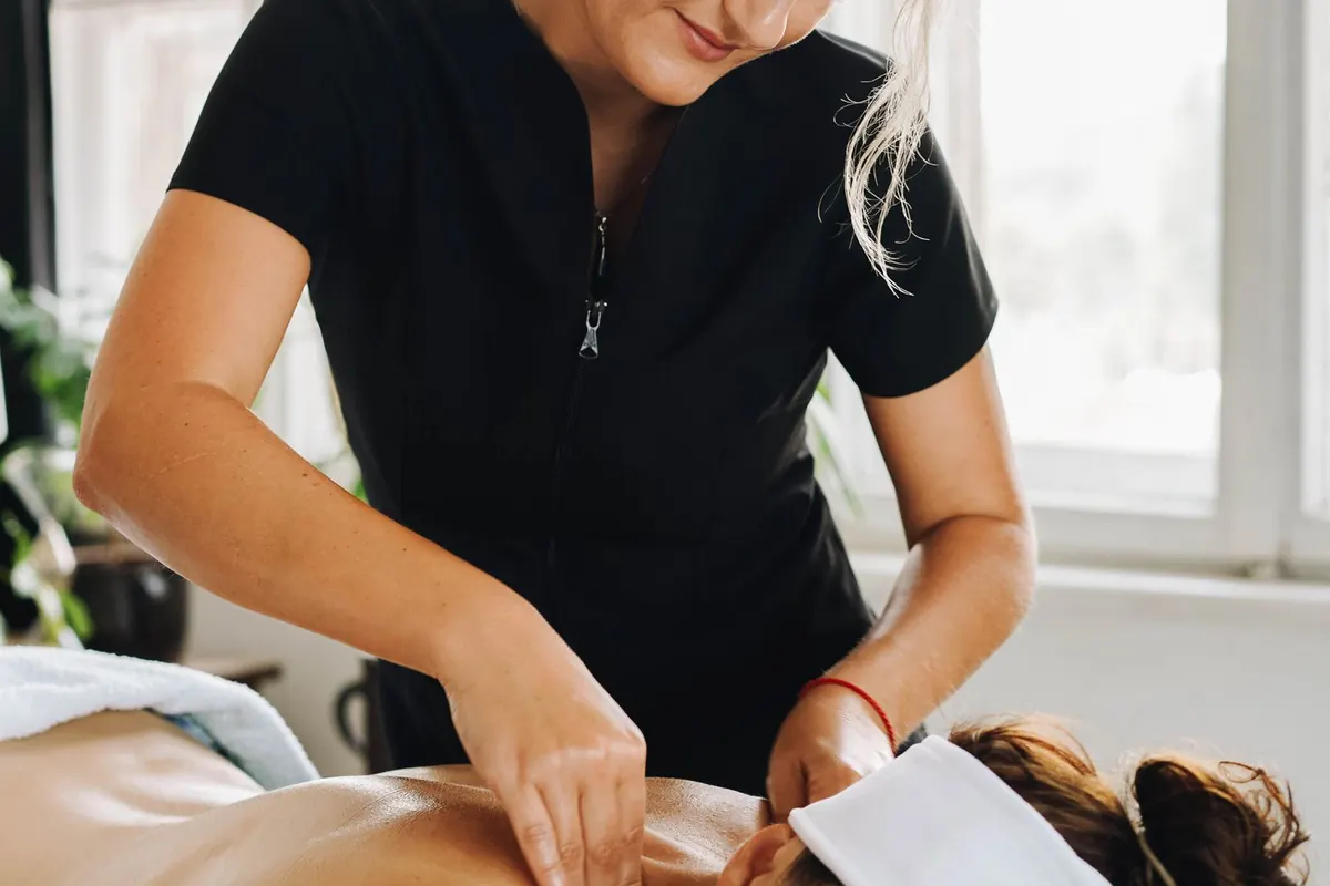 Client draped in a towel enjoying a calm relaxation back massage
